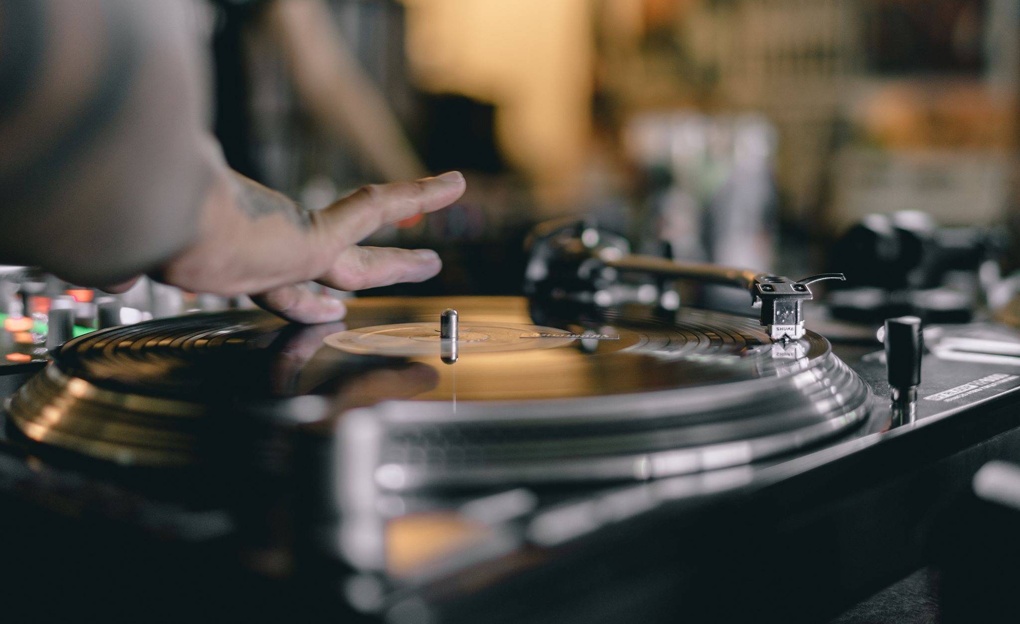 A DJ's hand on a spinning record